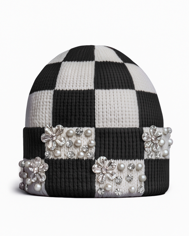 Black and white checkerboard beanie adorned with cherry blossom ornamentation, pearls and crystals on a white background